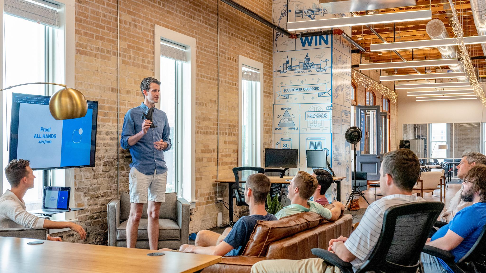 Presenter Leading a Team Meeting with a Screen Display