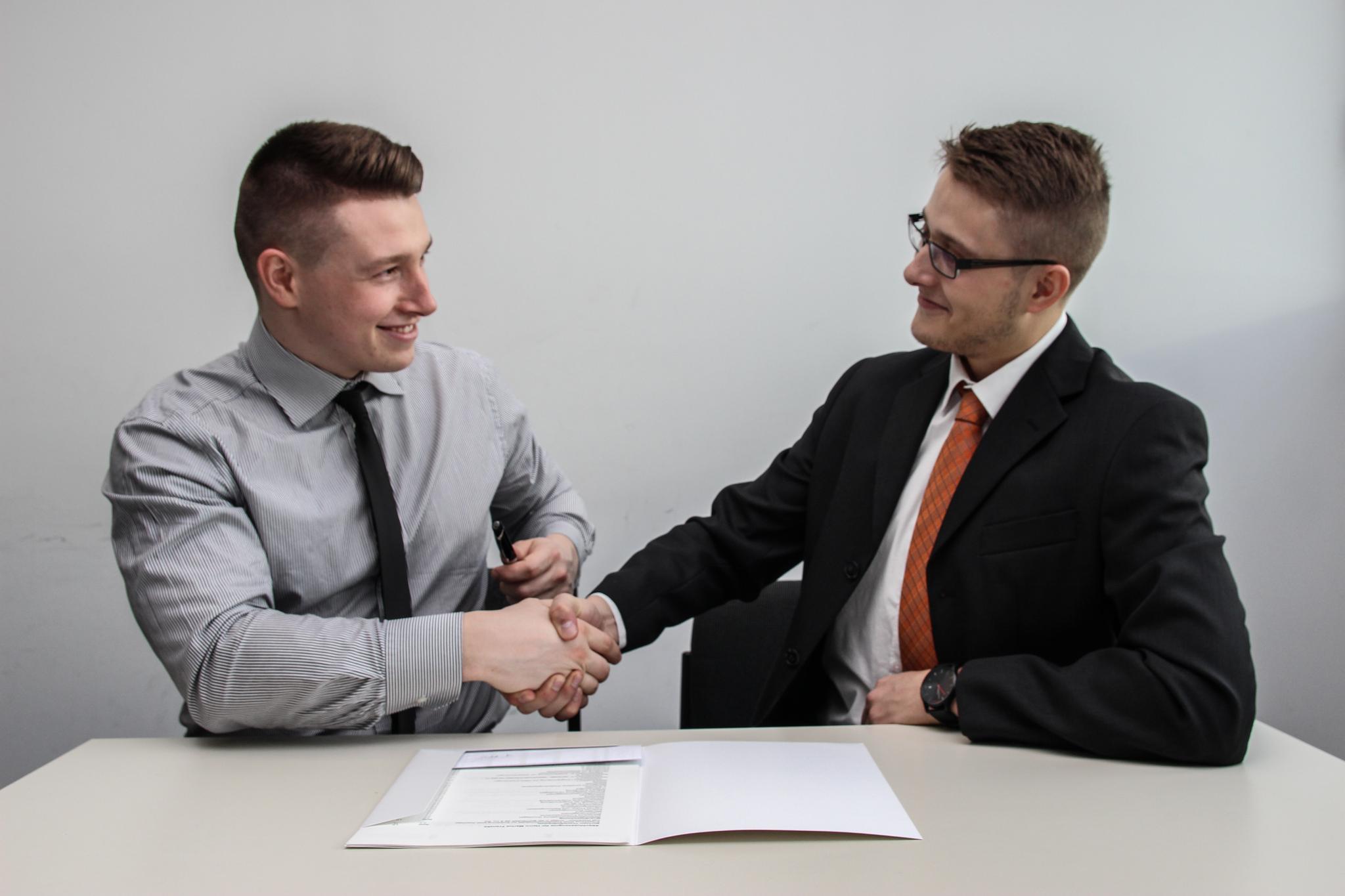 Two business partners shaking hands after successful agreement